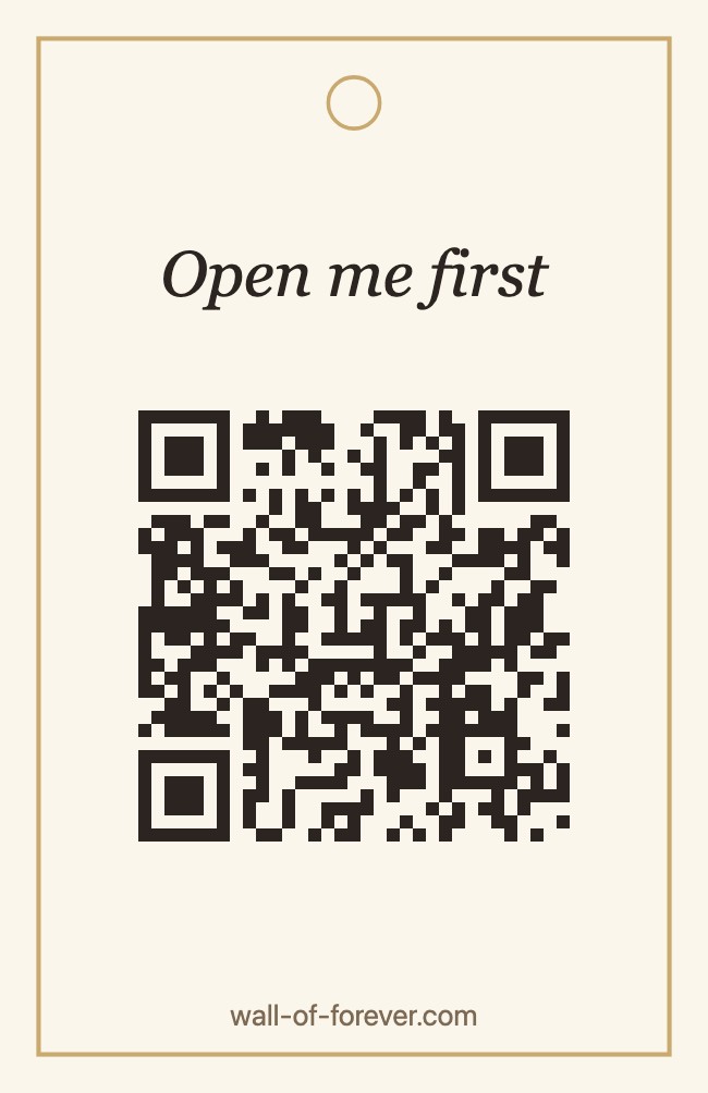 A small cream gift tag with a ribbon hole, a QR code and the words “Open me first”